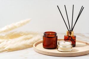 Scented Candles and Reed Diffuser on a Wooden Tray photo