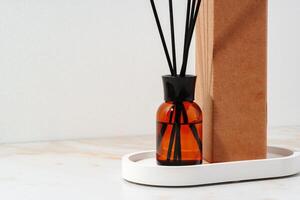 Amber Reed Diffuser On White Tray With Brown Box photo