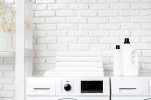 Two White Front Loading Washing Machines in Modern Laundry Room photo