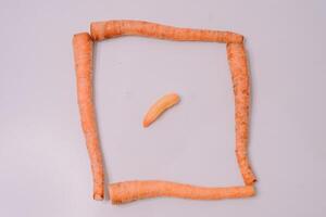 Fresh carrots displayed against a clean white background, highlighting their vibrant orange color and crisp texture photo