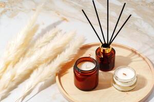 Scented Candles and Reed Diffuser on a Wooden Tray photo