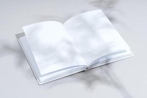 Blank open notepad on gray background studio shot photo