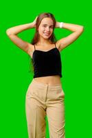 Smiling Young Woman in Black Top and Tan Pants Portrait photo