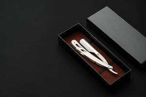 Barber shaving blade on black background close up photo