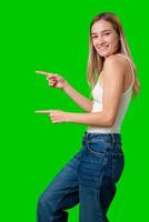 Smiling Woman Pointing To Both Sides In Front Of Green Screen photo