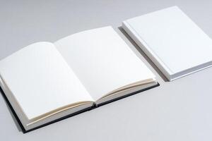 Blank open notepad on gray background studio shot photo