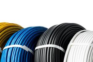 Four Spools of Electrical Wire in Yellow, Blue, Black, and White Colors. A Close-Up Photo of Four Spools of Electrical Wire, Each Wound in a Different Color.