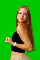 Young Woman Celebrating Success With Raised Fists Against Green Screen Background photo