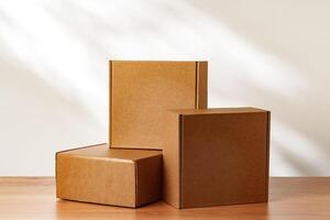 Three Cardboard Boxes Stacked on a Wooden Surface in a Room With Natural Light photo