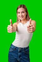 Smiling Woman Giving Thumbs Up In Front Of Green Screen photo