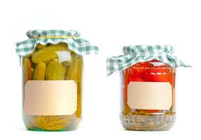Canned vegetables in glass jars isolated on white background photo