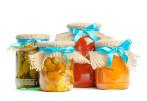 Canned vegetables in glass jars isolated on white background photo