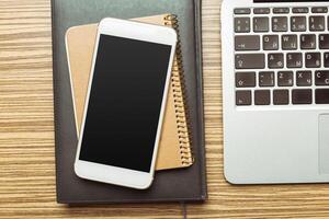 Office table with smartphone on it. View from above photo