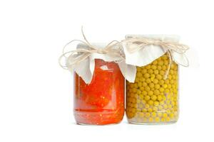 Canned vegetables in glass jars isolated on white background photo