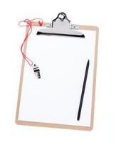A blank clipboard and a coaches whistle with copy space photo