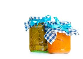 Canned vegetables in glass jars isolated on white background photo