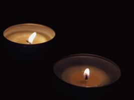 Scented candles in the dark at night for a spa or relaxation background. photo