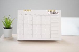 Desk calendar for December on the table with copy space in work space concept. photo