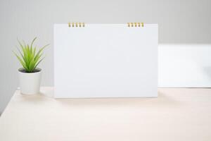 Blank desk calendar on table in mock up and copy space concept. photo
