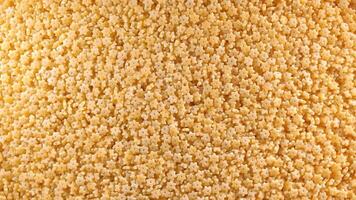 Uncooked Stelline Pasta. A Culinary Canvas of Stelle Macaroni, Creating a Lively and Textured Background for Gourmet Cooking - Top View, Rotating. Turning Dry Pasta. Raw Macaroni - Rotation video