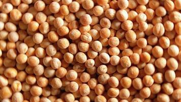 Uncooked Yellow Polished Peas. A Culinary Canvas of Dry Yellow Peas, Textured Background - Top View, Rotating. Turning Scattered Raw Polished Peas. Healthy Eating Ingredients - Rotation video
