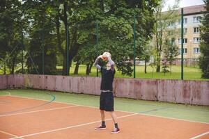 Volleyball player practicing setting the ball on a hard court, focusing on control and precision during an outdoor training session. A calm, focused moment in the game photo