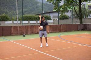 Volleyball player practicing ball control on a hard court, focusing on precision and movement during an outdoor training session. Captured in a calm, focused moment photo
