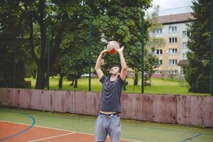 Volleyball player practicing setting the ball on a hard court, focusing on control and precision during an outdoor training session. A calm, focused moment in the game photo
