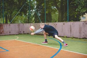 Volleyball player performing a digging on a hard court, focusing intently on the ball during an intense game. The action showcases skill, concentration, and athleticism photo