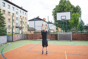Volleyball player practicing setting the ball on a hard court, focusing on control and precision during an outdoor training session. A calm, focused moment in the game photo