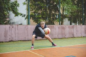Volleyball player performing a digging on a hard court, focusing intently on the ball during an intense game. The action showcases skill, concentration, and athleticism photo