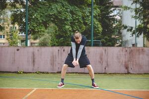 Volleyball player performing a digging on a hard court, focusing intently on the ball during an intense game. The action showcases skill, concentration, and athleticism photo