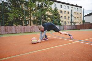 Volleyball player performing a digging on a hard court, focusing intently on the ball during an intense game. The action showcases skill, concentration, and athleticism photo