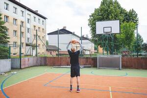 Volleyball player practicing setting the ball on a hard court, focusing on control and precision during an outdoor training session. A calm, focused moment in the game photo