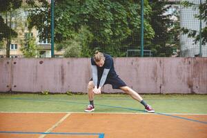 Volleyball player performing a digging on a hard court, focusing intently on the ball during an intense game. The action showcases skill, concentration, and athleticism photo