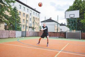 Volleyball player is passing on a hard court during an outdoor practice session. The action captures focus, movement, and ball control in a casual game setting photo