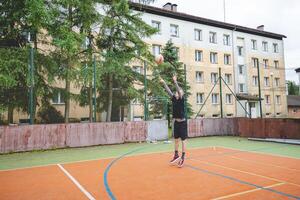 Volleyball player practicing setting the ball on a hard court, focusing on control and precision during an outdoor training session. A calm, focused moment in the game photo