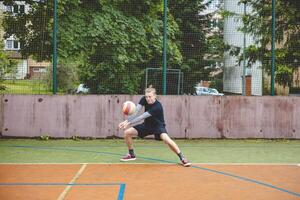 Volleyball player performing a digging on a hard court, focusing intently on the ball during an intense game. The action showcases skill, concentration, and athleticism photo
