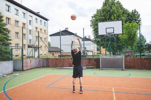 Volleyball player practicing setting the ball on a hard court, focusing on control and precision during an outdoor training session. A calm, focused moment in the game photo