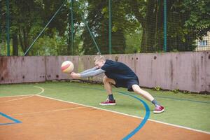Volleyball player performing a digging on a hard court, focusing intently on the ball during an intense game. The action showcases skill, concentration, and athleticism photo