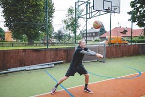 Volleyball player is passing on a hard court during an outdoor practice session. The action captures focus, movement, and ball control in a casual game setting photo