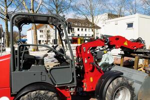 Cabin of a red tractor at a construction site. photo