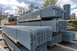 Long metal grating stacked in stacks at a construction site. photo