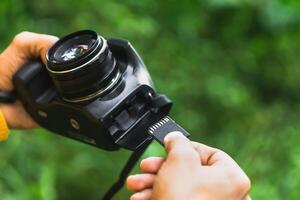 Hands of a Photographer inserting the memory card into the camera. technology and backup concept. photo