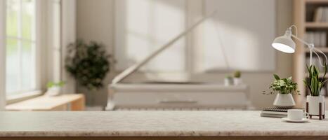 A close-up of a a tabletop in a bright room with a white grand piano in the background. photo