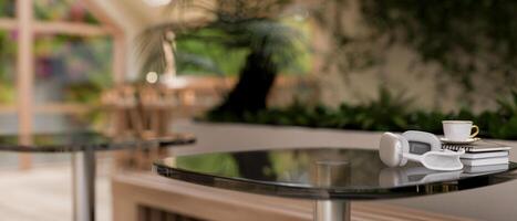 A space for displaying products on a table in a contemporary coffee shop with indoors garden. photo