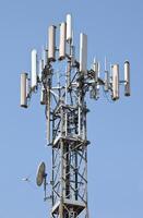 A tower with many antennas on it photo