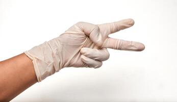 Person with latex gloves showing number two on white background photo