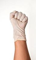 Latin doctor's hand glove showing fist on white background. photo