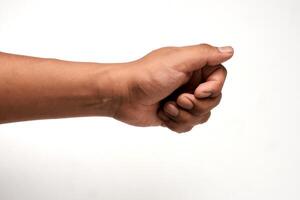 Hand of a Latino man holding something, partially closed in the shape of a fist, isolated on white background. Gesture indicating a grip or a hold, ideal for interaction and communication concepts. photo